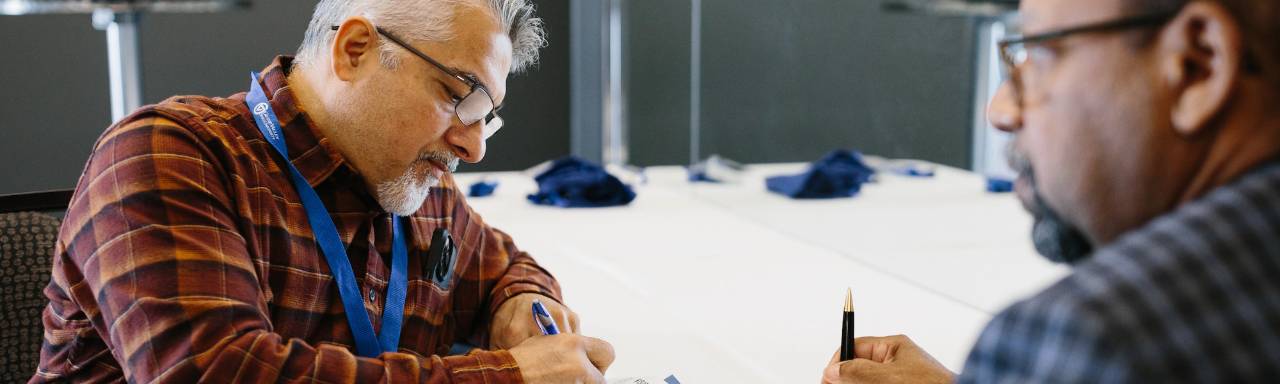 Two school board presidents work together at a training seminar